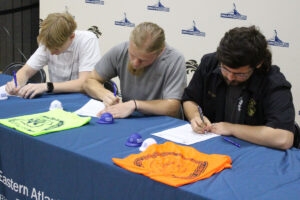 Seated, from left, are Landen Nelson, Jude Kesner-Rankin and Joseph Rogers signing their letters of intent.