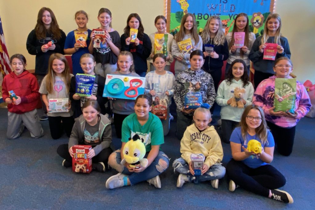 Group picture of the Hilltop Elementary Kindness Crew holding donations for the Marshall County Animal Shelter.