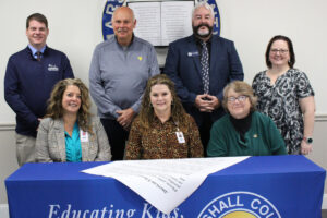 Pictured from left front row: MCS Assistant Superintendent Karen Klamut, MCS Superintendent Dr. Shelby Haines and MCS BOE Vice-President Christie Robison. Back row from left: Marshall County AFT President Josh Gary, Marshall County Commission President Mike Ferro, MC Chamber Executive Director Scott Reager and MCEA President Stephanie Brown.