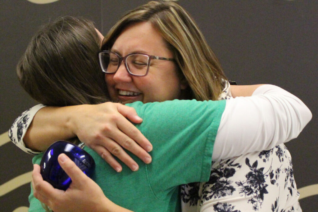 Alexa Bushovisky shares a joyful hug with Kathleen Loughman, Science Department Chair, after being surprised to learn that Kathleen nominated her for the Above and Beyond Award.