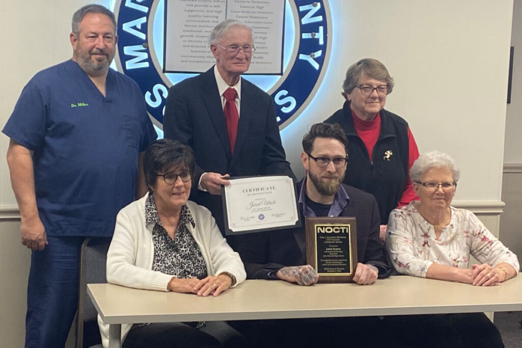 Jared Ulrich was honored at the December BOE meeting for his accolade. Seated from left: MCS BOE member Lori Kestner, Jared Ulrich and MCS BOE member Brenda Coffield. Standing from left: BOE member Dr. Duane Miller, MCS BOE President John Miller and BOE Vice-President Christie Robison.