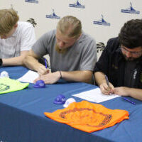 Seated, from left, are Landen Nelson, Jude Kesner-Rankin and Joseph Rogers signing their letters of intent.