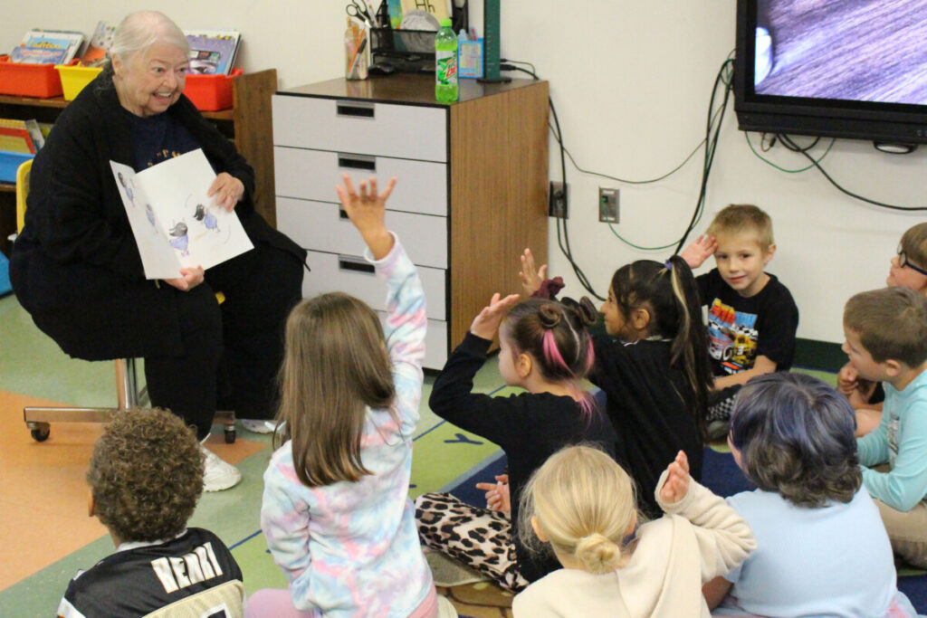 Retired JMHS Math teacher Ruth Crow reads to first graders at McNinch Primary School during the annual Read for the Record Day.