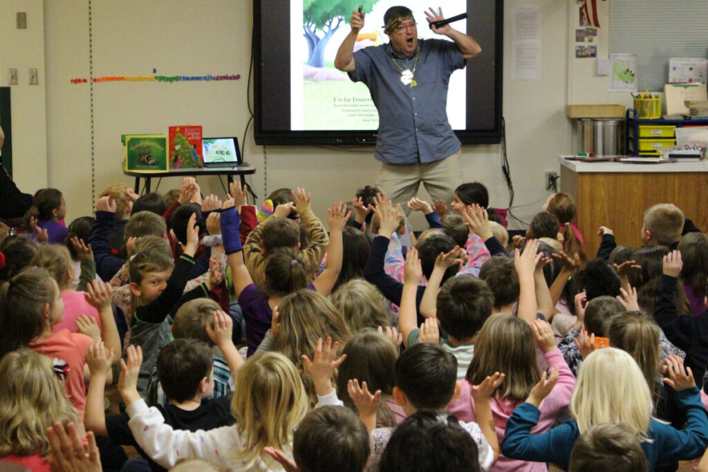 Mike Shoulders raps one of his books to McNinch Primary students.