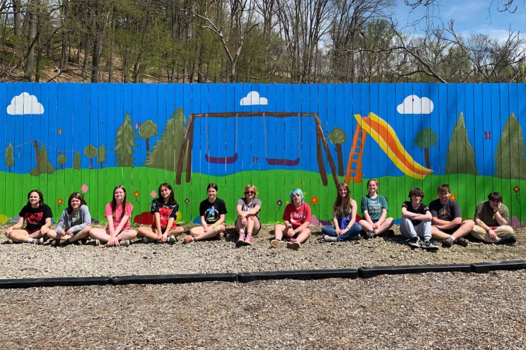 Pictured are the student artists in front of the finished mural at Grand Vue Park.