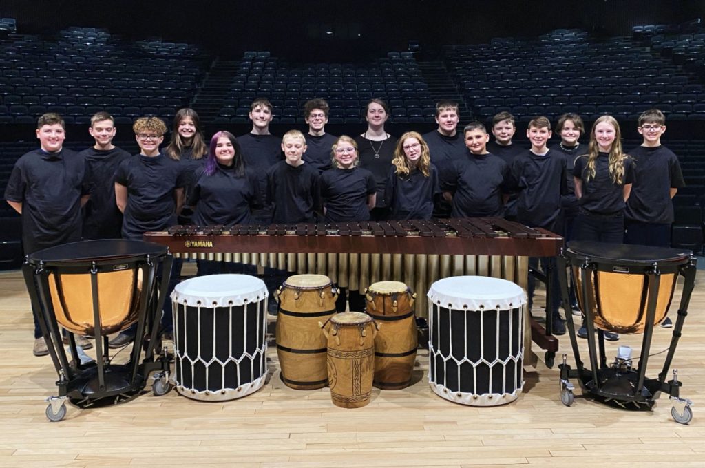 Group of students standing on the JMHS CPA stage in back of a xylophone.