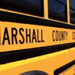 Side view of yellow Marshall County Schools bus.