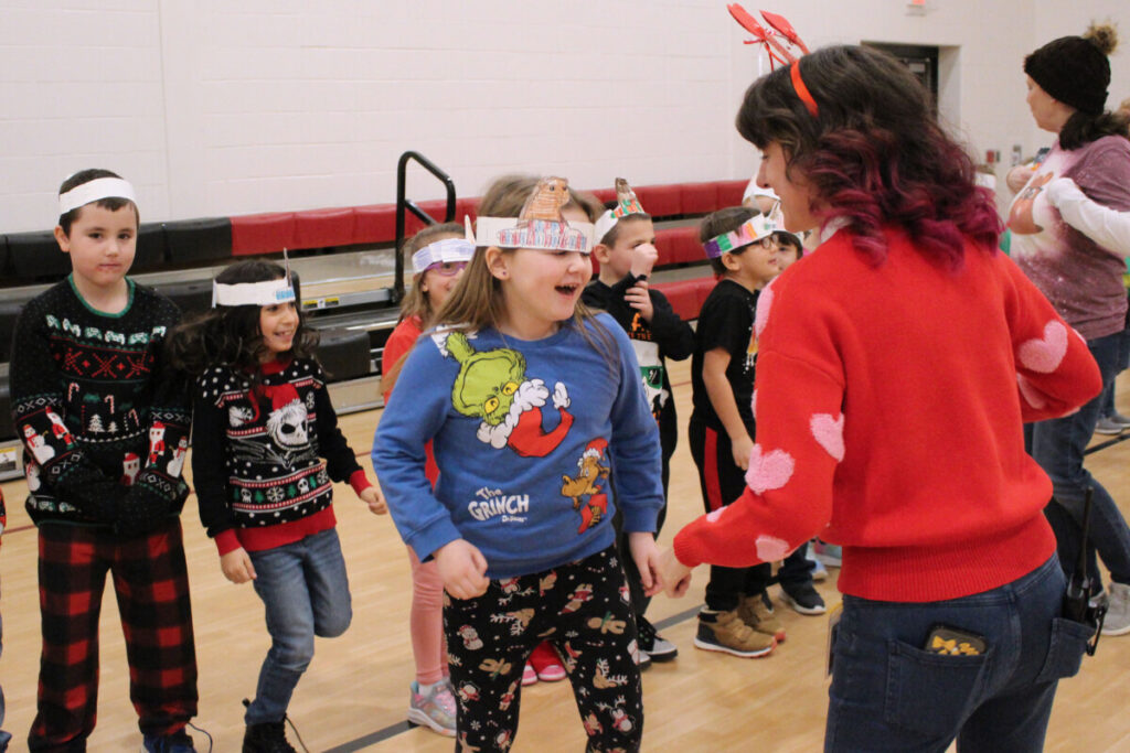 WLES students and faculty Do-si-do to the “Chicken Dance Song.”